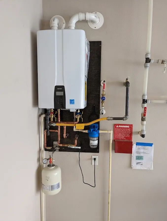 Professional plumber installing copper piping in a Leander home